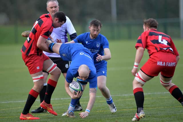 Hawick Linden's Matthew Huggan being upended by Angus Tullie during their 23-0 win at home at Volunteer Park on Saturday to Duns (Photo: Alwyn Johnston)
