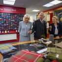 The King and Queen look over some tartans with managing director Dawn Robson-Bell. Photo: Ian Georgeson.