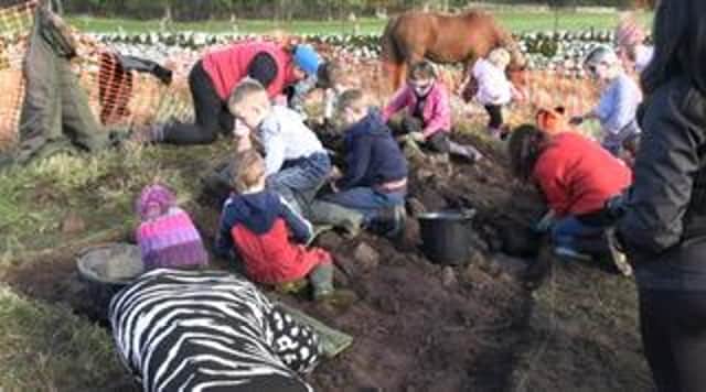 Schoolkids participate in the archaeological dig.