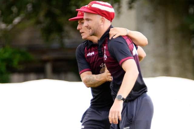 Selkirk skipper Daniel Heard, back, congratulating teammate Rory Banks on a catch out on the midwicket boundary, off the bowling of Greg Fenton, during a two-wicket loss for the Souters at home to Tranent and Preston Village seconds on Saturday (Photo: John Smail)