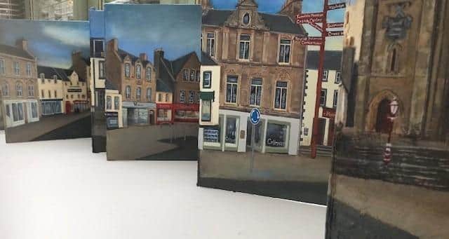 The artwork shows both north and south sides of the High Street in Peebles.