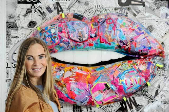 Mixed-media artist Wendy Helliwell with one of her colourful lips artworks, made using pages from Vogue plumped up with recycled jeans. Photo: Colin Hattersley.