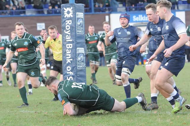 Andrew Mitchell scoring his first try, watched by Calum Renwick, during Hawick's 59-3 away win against Selkirk at Philiphaugh on Saturday (Photo: Grant Kinghorn)