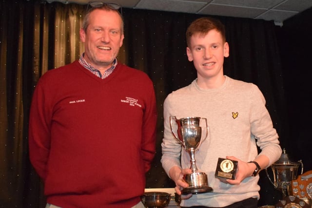 Teviotdale Harriers under-17 champion Irvine Welsh being presented with his prize by club preseident Paul Lockie