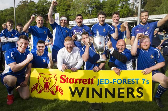 Jed-Forest celebrating winning their own sevens tournament with sponsors Ryan Briggs and, representing Starretts, commercial director Robert McKechnie