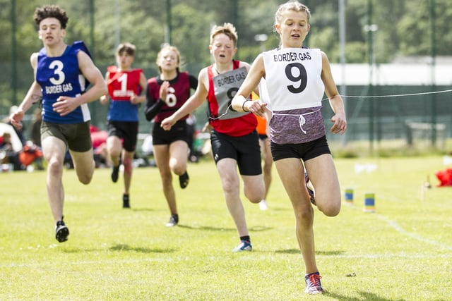 Hawick's Carra McLeod, right, taking part in a heat for the youths' 200m handicap on Sunday