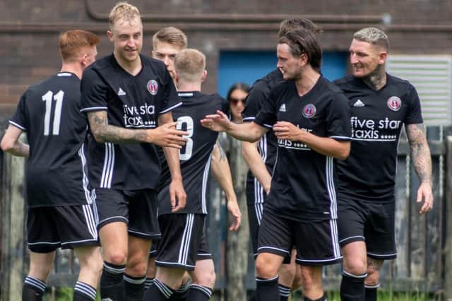 Gala Fairydean Rovers' Daryl Healy being congratulated on scoring during their 4-2 defeat by a Hearts XI yesterday (Photo: Thomas Brown)