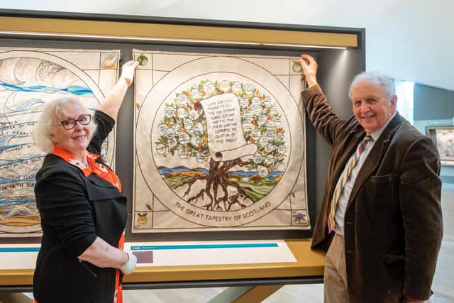 Stitcher coordinator Dorie Wilkie and tapestry visionary Alexander McCall Smith hang the final panel into place in the new home of the Great Tapestry of Scotland in Galashiels. Photo: Phil Wilkinson.