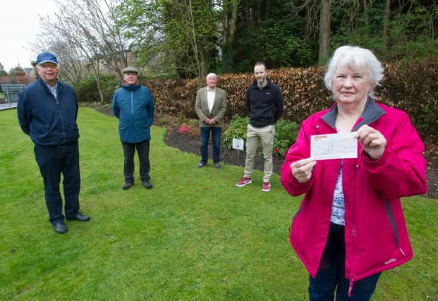 Members of Gala in Bloom, John Gray, Alaistair Waddell and Ken Hay at Bank Street with Judith Cleghorn receiving a cheque from Dalgetty's Bakery owner Craig Murray. The money was raised bu customers of the bakery. (Photo: BILL McBURNIE)