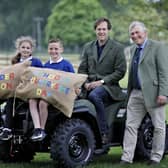 The Duke of Roxburghe (seated) gets ready to welcome primary five children from across the  Borders to the Border Union Schools Countryside Day , with Poppy Johnston and Ruari Patterson from Broomlands Primary and Border Union Agricultural Society chair, Peter Douglas. Photo: Paul Dodds.