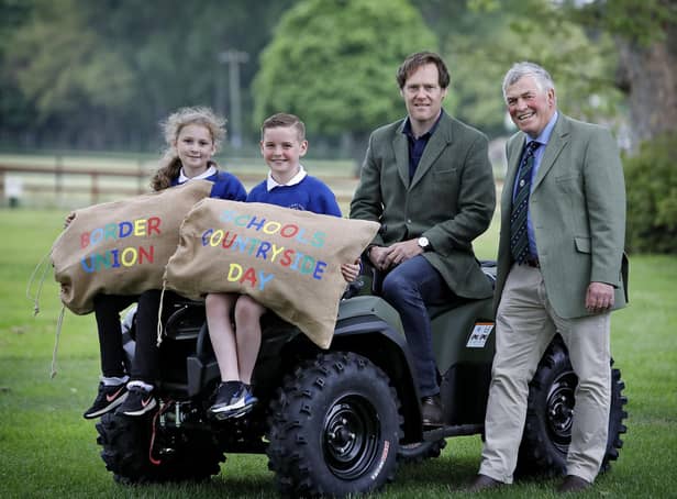 The Duke of Roxburghe (seated) gets ready to welcome primary five children from across the  Borders to the Border Union Schools Countryside Day , with Poppy Johnston and Ruari Patterson from Broomlands Primary and Border Union Agricultural Society chair, Peter Douglas. Photo: Paul Dodds.