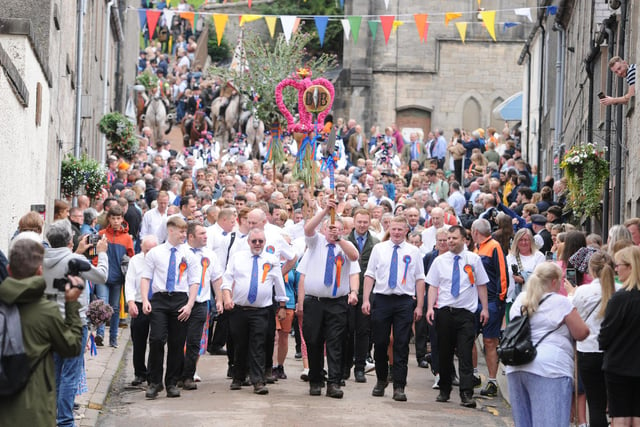 Langholm's traditional emblems lead the riders back down the Kirk Wynd.