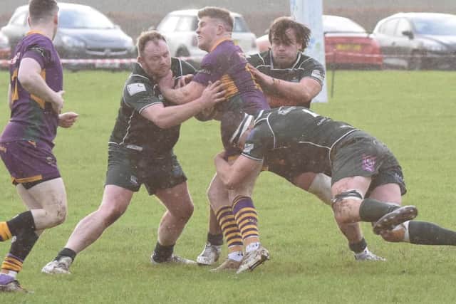Hawick players combining to halt a Marr attack on Saturday (Pic: Malcolm Grant)