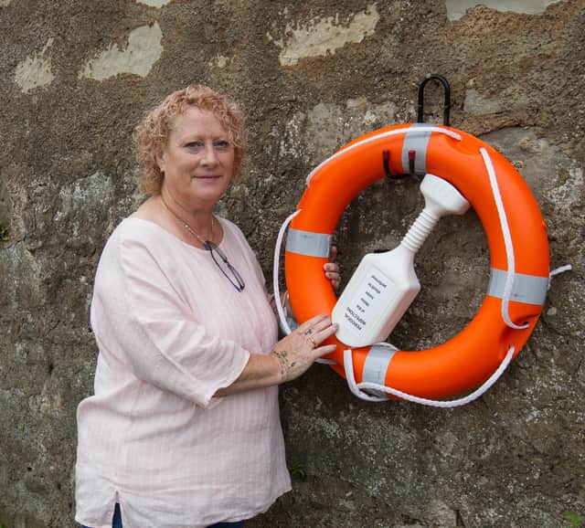 Anne Moriarty at the newly installed lifebuoy at the Cobby, Kelso. (Photo: BILL McBURNIE)