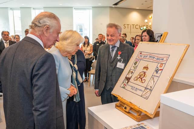 King Charles and Queen Camilla with the new panel, with artist Andrew Crummy. Photo: Phil Wilkinson.