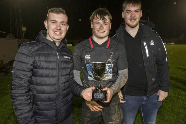 Jock and Jocelyn Todd's grandsons Owen and Ewart Sanderson presenting a new trophy named after them to Kelso Harlequins captain Mitchell Laing (Photo: Bill McBurnie)
