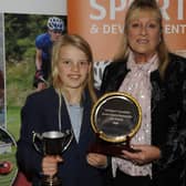 Junior sports personality award-winner Cali Nelson being presented with her trophy by Pauline Weir