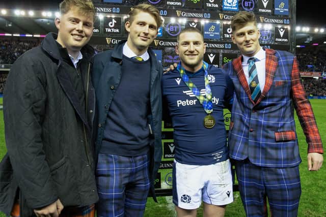 Scotland's Finn Russell being presented with his award for being player of the match against wales on Saturday by Doddie Weir's sons Hamish, Ben and Angus at Edinburgh's Murrayfield Stadium on Saturday (Photo by Craig Williamson/SNS Group/SRU)