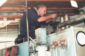 Billy Fleming at work on a machine at the mill.