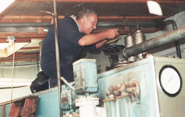 Billy Fleming at work on a machine at the mill.