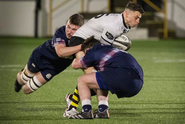 Melrose full-back Donald Crawford being tackled by Selkirk's defence (Photo: Bill McBurnie)