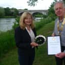 Lynn Young is presented with her award by Kelso Rotary Club president Ian Ross.