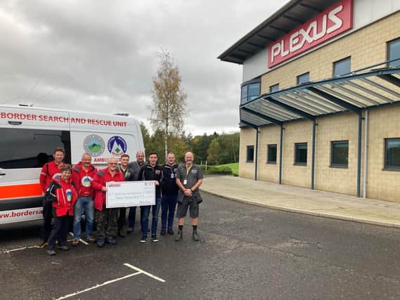 The Plexus team hand their £8,675 prize to Borders Search and Rescue.
