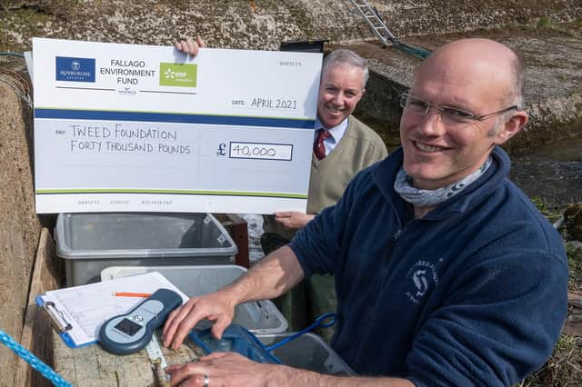 Fallago Environment Fund chairman Gareth Baird presents a cheque for £40,000 to Tweed Foundation biologist, James Hunt to help fund a smolt-tracking survey that aims to improve Atlantic Salmon stocks on the River Tweed. The young migrating salmon will be fitted with tiny acoustic tags and monitored as they head downstream with the aim of identifying future strategies that ensure as many as possible make it out to sea. Photo: Phil Wilkinson.