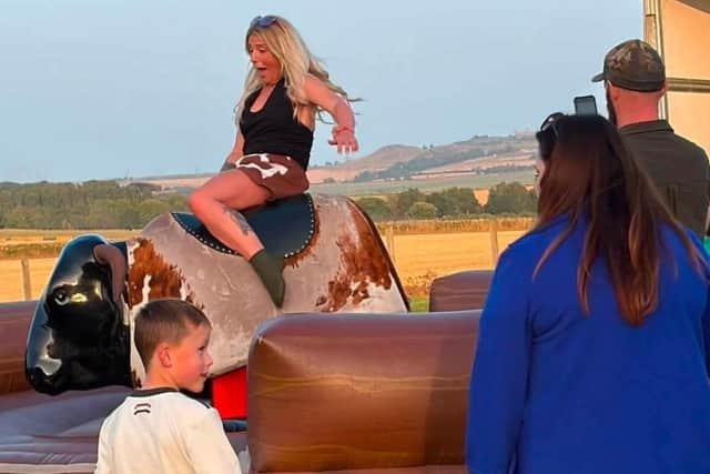 The bucking bronco proved a popular attraction at the village's music festival.