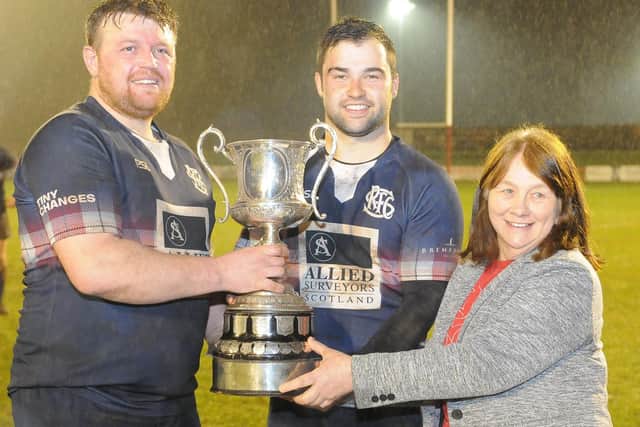 Border League president Fiona Skeen presenting Selkirk co-captains Luke Pettie and Aaron McColm with their trophy on Monday (Pic: Grant Kinghorn)