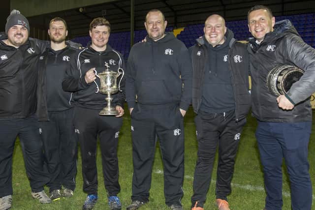 Head coach Matty Douglas, third from left, and the rest of Hawick's coaching team holding the Border League Cup (Photo: Bill McBurnie)