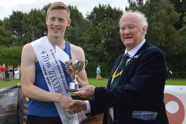 Tweed Leader Jed Track's Scott Tindle being presented with his prize for winning the 70m open at Sunday's Bowhill Highland Games (Photo: Royal Scottish Highland Games Association)