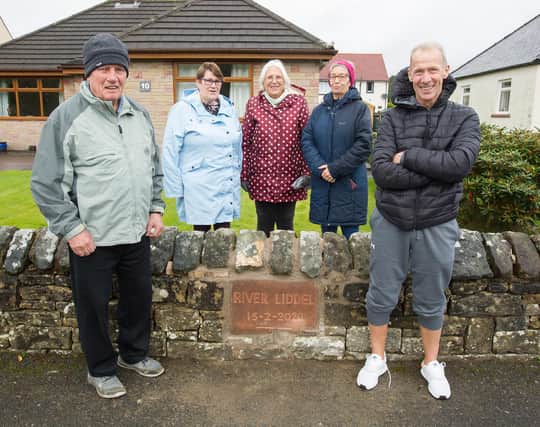 Retired stonemason Billy Armstrong (Thumbie) unveils his flood marker stone, with Community Councillor Greg Cuthbert and neighbours, Cathy Jamieson, Sandra Hope and Janet Moore. (Photo: BILL McBURNIE)
