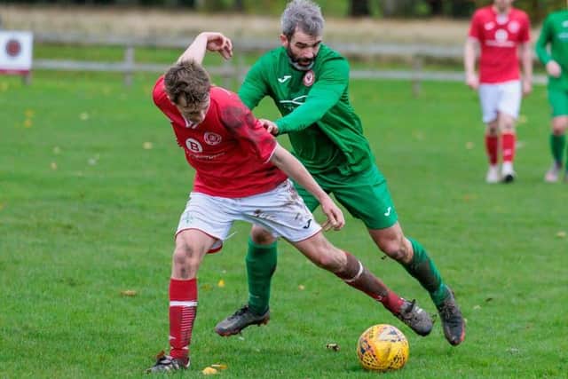 Edinburgh South player-manager Ainslie Hunter getting pushy with Fraser Stewart at Peebles Rovers' Whitestone Park home ground on Saturday (Pic: Pete Birrell)
