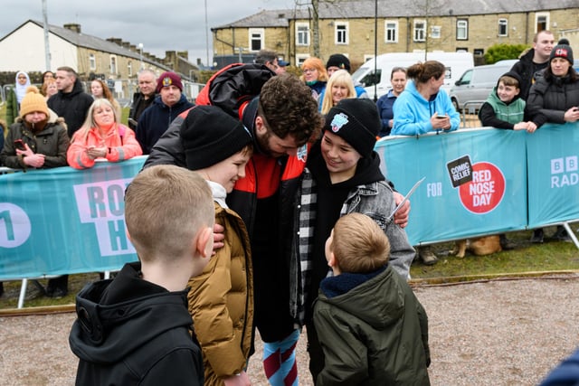 Hughie Higginson and Freddie Xavi greet Jordan North at the completion of his 100 mile rowing challenge in aid of Comic Relief. Photo: Kelvin Stuttard