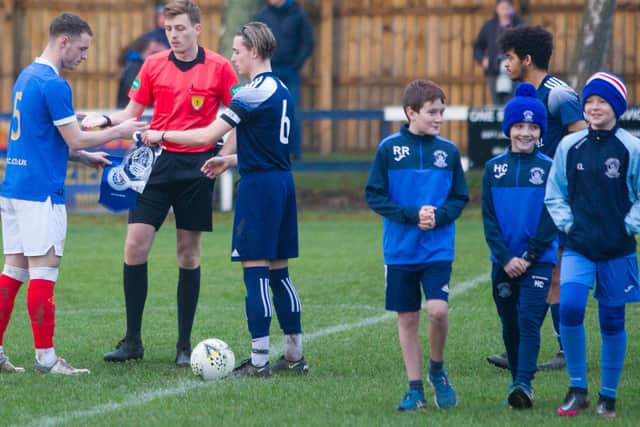 Club captains Leon King, of Rangers B, and Michael Robertson, of Vale of Leithen, exchanging pennants prior to kick-off (Photo: Bill McBurnie)