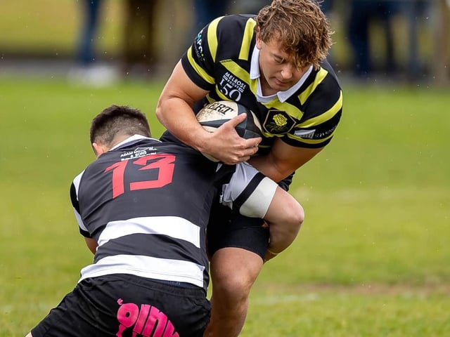 Full-back Callum Anderson in possession for Melrose, with Adam Hall tackling, as they lost 39-22 away to Kelso at Poynder Park on Saturday (Photo: Andy McLean)