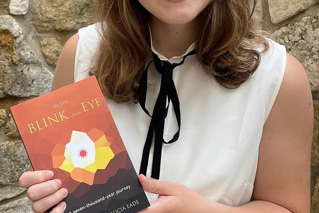 Lucia with the book 'In the Blink of an Eye'.