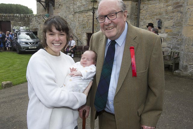 Lord Lothian, Michael Ancram, with his new grandson at Ferniehirst Castle on Festival Day.