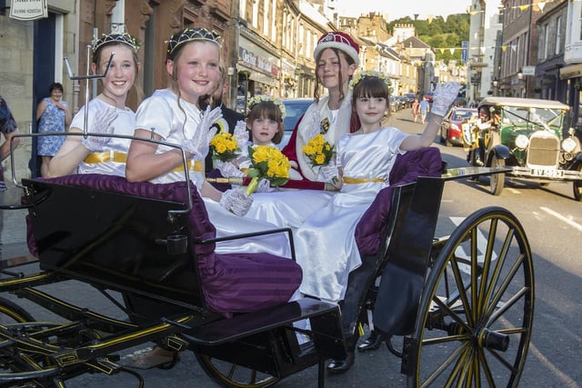 Festival Queen Madeline Rausse and ladies in waiting are led around the town in a carriage.