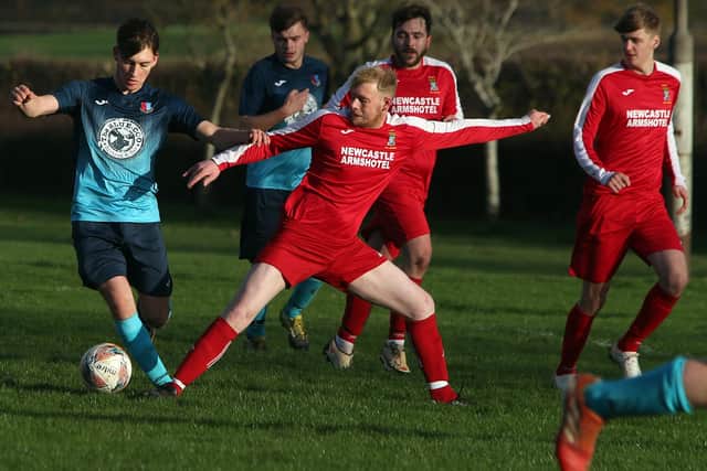 Coldstream Amateurs' Ross Allan trying to block a shot by Lee Macrae for St Boswells (Pic: Steve Cox)