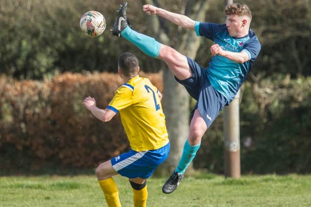 St Boswells' Connor Shepherd going for a high ball against Hawick Colts (Photo: Bill McBurnie)
