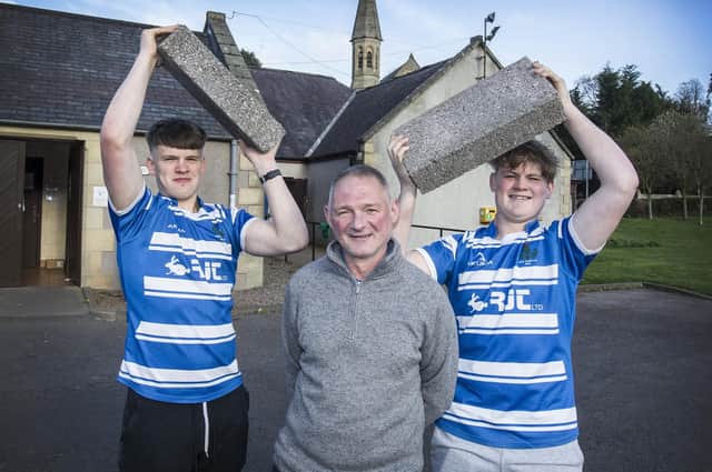 Jed Thistle captain and scrum-half Hector Patterson, president Bruce Cowan and hooker Callum Davidson lifting blocks they hope to sell for £20 each to help pay for an £80,000 refurbishment of their clubhouse (Pic: Bill McBurnie)