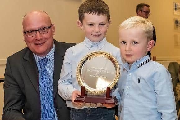 Rory and Ellis Wilkinson collecting Samantha Kinghorn's shared sports personality of the year award from John McBay at Club Sport Berwickshire's latest prize-giving, held in Duns (Pic: Mark Kinghorn)