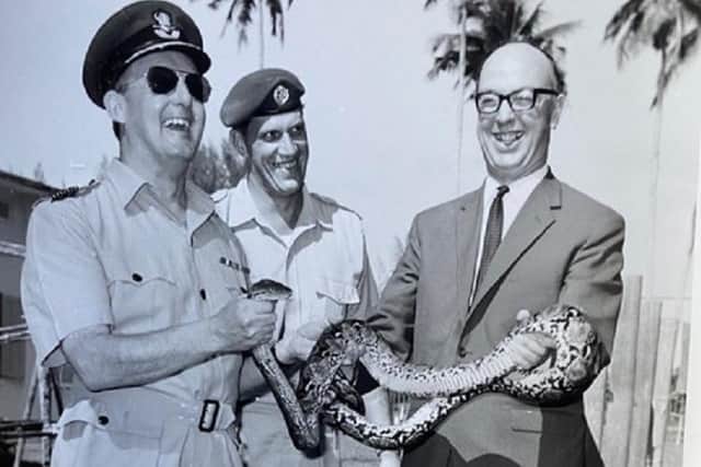 Alfred (holding the snake) in Singapore in 1964 with colleagues in the RAF.