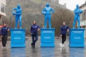 From left, Lisa Thomson, Donna Kennedy and Francesca McGhie in Edinburgh's Castle Street with their blue plastic statues intended to inspire more girls to take up rugby (Pic: Robert Perry/PinPep)