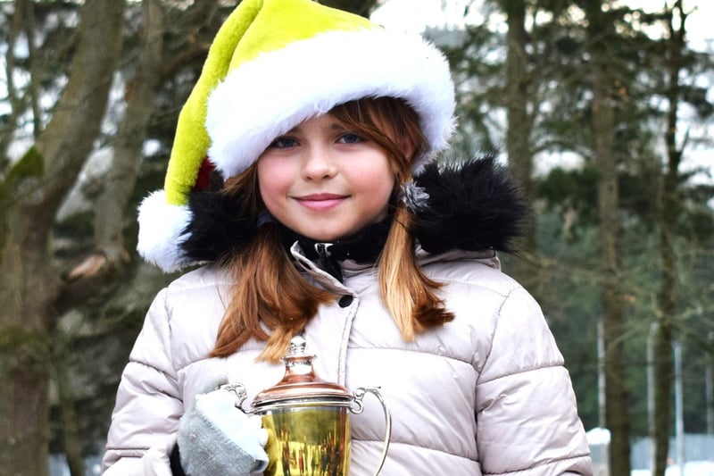 Hawick Burns Club race-winner Mia Swistek at Sunday's Teviotdale Harriers Christmas relays after being presented with a trophy unavailable on the day