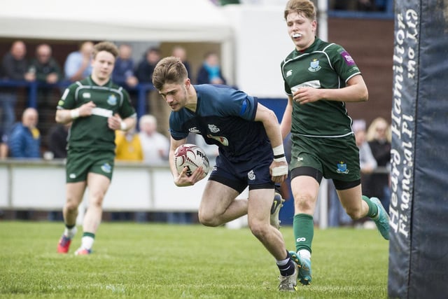 Selkirk's Finlay Wheelans goes over the line to score a try against Hawick at his club's sevens