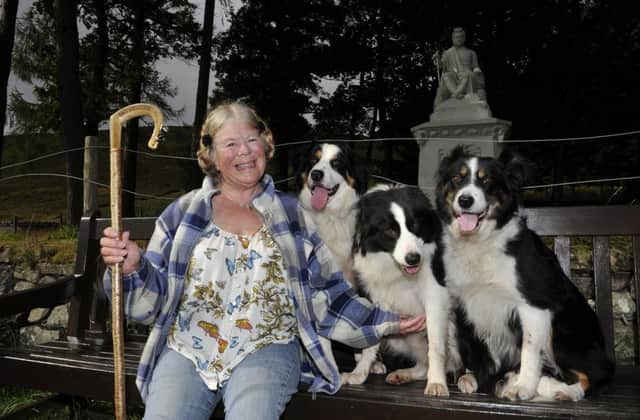 Author and shepherdess Viv Billingham Parks with her sheep dogs at the statue of The Ettrick Shepherd, James Hogg.