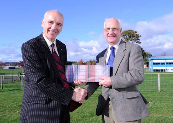 QMS chief executive Uel Morton, left, presents Jim Brown with a gift at his retirement farewell at Ingliston last month.